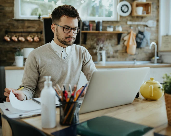 Small business owner managing bookkeeping on a laptop